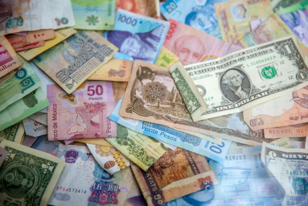 bills of different currencies in a mixture of notes showing results of how to get rich with passive income